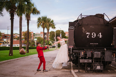 two brides posing for a photo on a train at Sunset Station wedding venue in downtown San Antonio