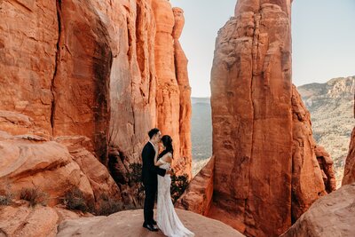bride and groom on red rocks