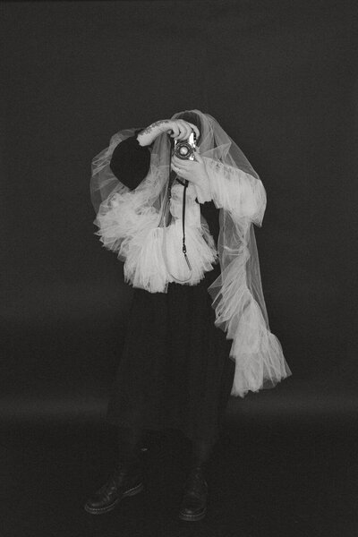 photographer under a veil taking a photo