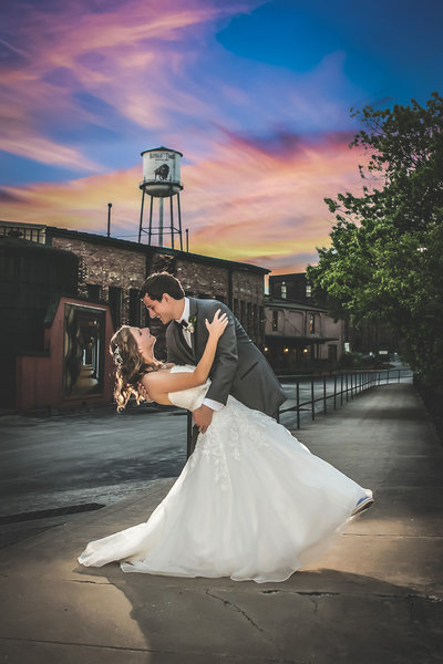 Kentucky Groom dips Bride at Buffalo Trace Distillery at sunset in bourbon country.