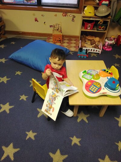 Toddler Reading a Book CPC Albuquerque Childcare