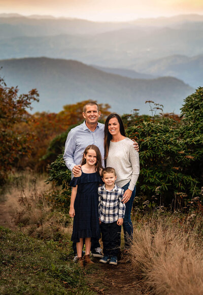 A family poses for a portrait with Valerie Eidson Photography at Craggy Gardens near Asheville NC