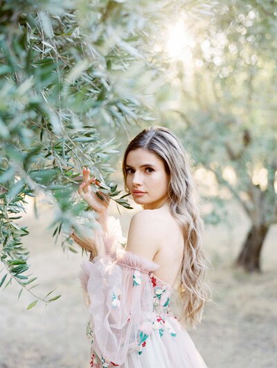 Olive grove fine art portraiture, olive grove portrait, girl in pastel pink embroidered floral dress and tulle holding lavender colored bouquet, bridal portraits, prewedding photographer, napa wedding photographer, napa photographer, napa portrait photographer