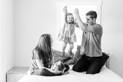 family playing on the bed