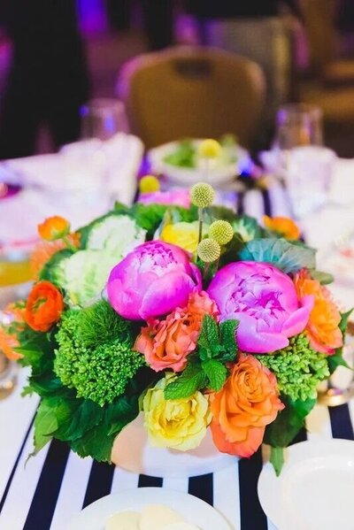 Vibrant centerpiece with bright flowers on a table.
