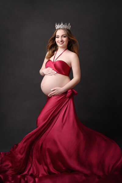 Maternity photoshoot in West Palm Beach of pregnant mom in beautiful pink couture gown.