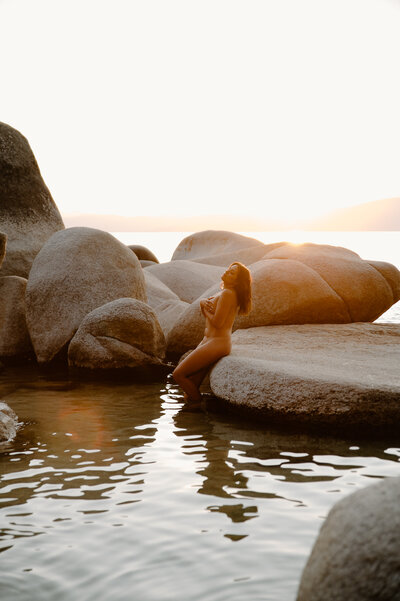 Golden hour nude portrait of a woman in Lake Tahoe surrounded by large granite boulders – intimate, natural, and artistic boudoir photography, YG After Dark Boudoir