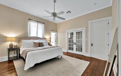 Master bedroom with French doors in this 3-bedroom, 2-bathroom vacation rental home near the Silos and Baylor in Waco, TX