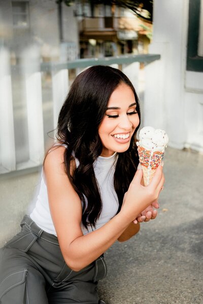 woman holding an ice cream cone smiling