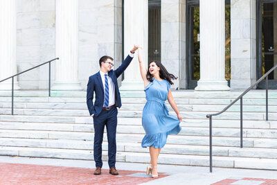 Couple wearing blue dancing in front of the Toledo Museum of Art steps in Toledo, Ohio