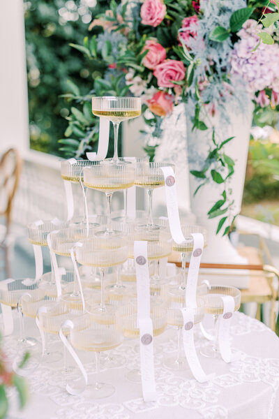 Champagne tower with flowers in background