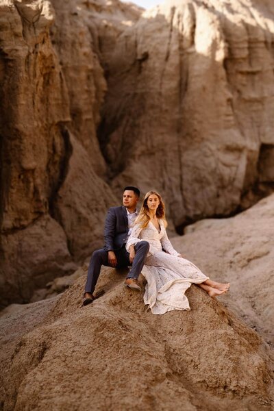 Couple sitting together on a rock in Anza Borrego State Park slot canyon in California.