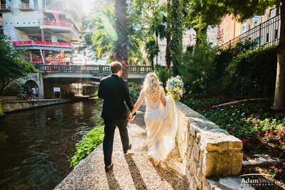 Bride and groom walking on San Antonio river walk