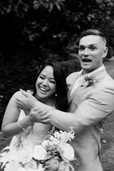 A film wedding portrait of a couple laughing at their wedding in Whakatane by Eilish Burt Photography