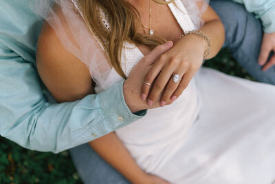 Sacramento Wedding Photographers capture man holding woman's hand with engagement ring