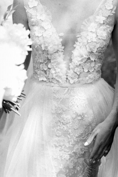 Black and white image of brides elegant wedding dress for her Colorado wedding