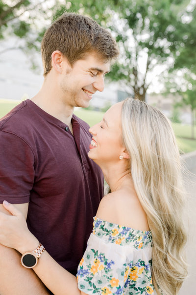 A couple facies each other and  laughs during an engagement session in Cincinnati, Ohio
