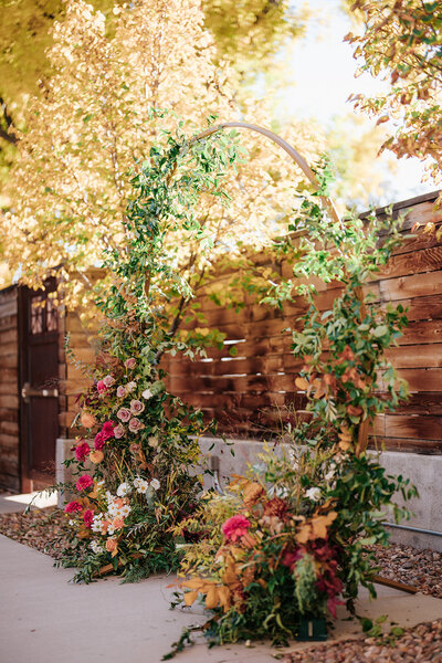 Circular arch with florals at fall wedding at the St Vrain