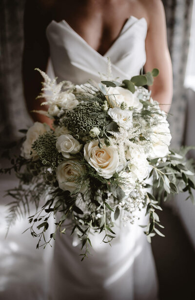 bridal  bouquet with minimal white flowers and green foliage
