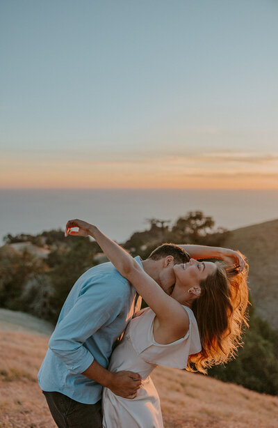 man kisses his fiances neck during romantic engagement photos