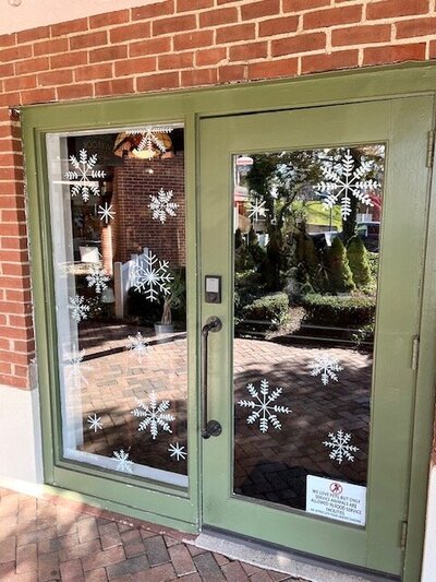 Hand drawn snowflakes on storefront windows of Cheshire, Connecticut business