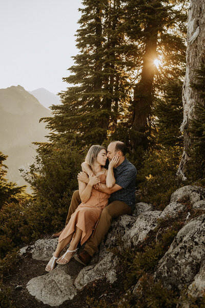 couple snuggling on mountain