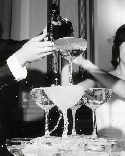 wedding couple pouring champagne into a champagne tower at Fairmont Hotel Vancouver
