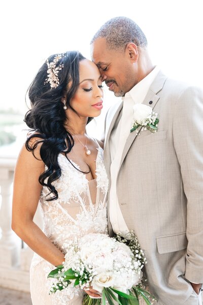 Bride with tropical bouquet and flower crown basks in sunset beauty