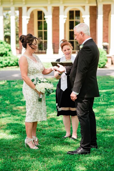Nashville wedding officiant marrying bride in a lace dress and groom in a black suit at Oaklands Mansion