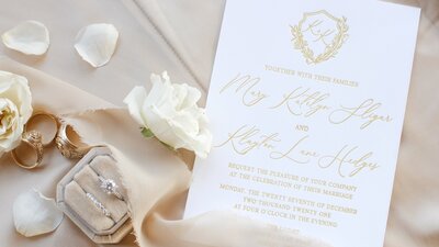 Pink and gold luxury wedding invitation sitting on a table