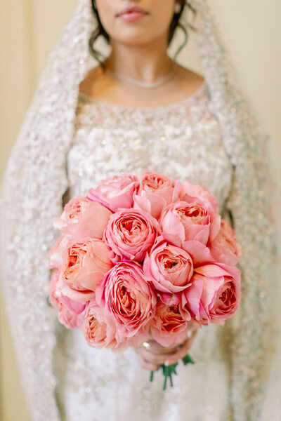 Bride holding pink flower bouquet, Rosecliff Mansion wedding