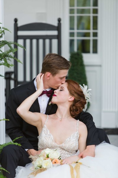 great gatsby wedding couple embracing on Parterre front porch