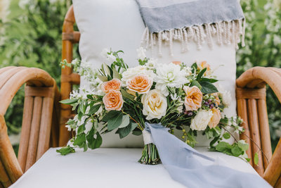 bridal bouquet sitting on chair
