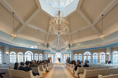 Wedding Ceremony Inside a Chapel During with a Grand Chandelier a Walt Disney World Wedding