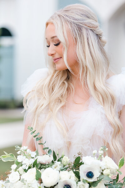 bright light and airy wedding photo of bride with boquet