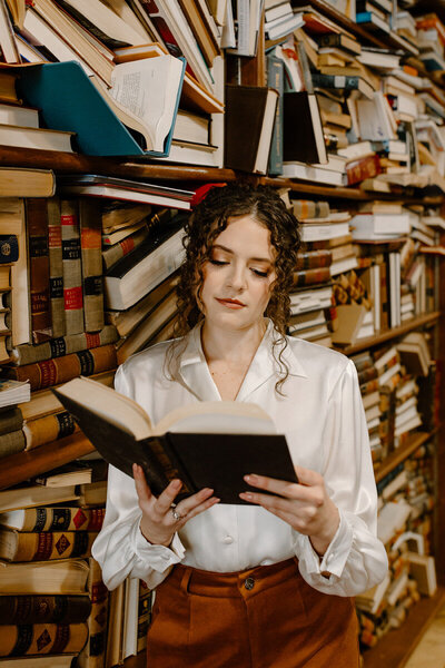 woman reading a book in a library