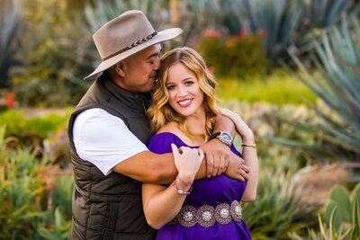 Couple posing for engagement portrait in Rose Haven Heritage Garden in Temecula