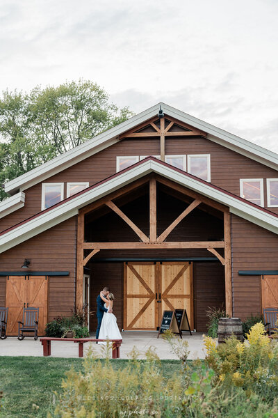 bride and groom outside the barn at barnwood events in madison, winconsin.