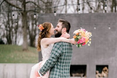 Couple hugging in front of fireplace