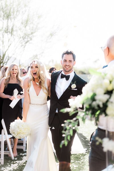 Andaz Scottsdale Ambers Lawn Ceremony  Recessional Bride and Groom laughing