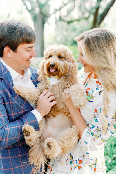 Couple posing with their dog during their downtown Savannah engagement session