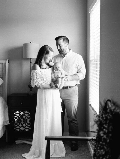 Mom and Dad hold their newborn baby at their photo session in Murfreesboro, TN