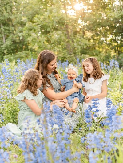 a mom in a flower field with her kids