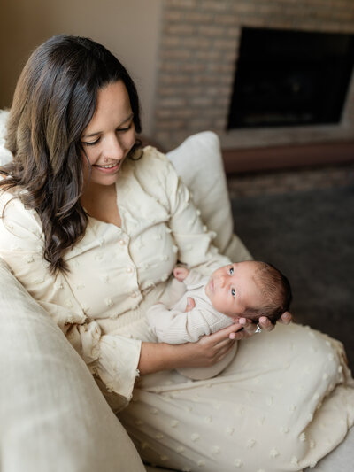 mom holding newborn baby boy for in home lifestyle session