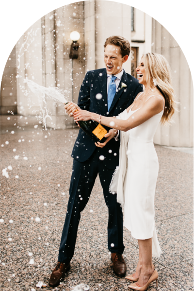 couple opening a champagne bottle