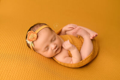 baby girl wrapped in yellow for her newborn photography session in cleveland ohio