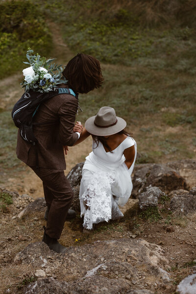 bride and groom climbing