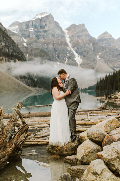 couple standing on a rock at a banff elopement