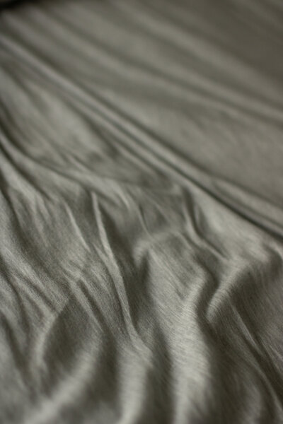 Close up shot of grey sheets to capture texture.