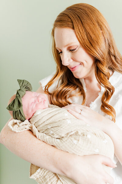 woman holding her newborn baby